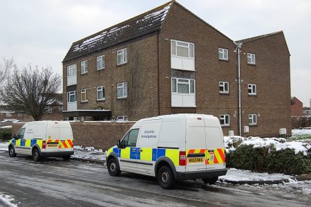 Police crime scene investigation vehicles outside a property in Willow Close.