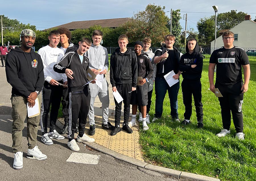 Photo of a group of students holding envelopes.