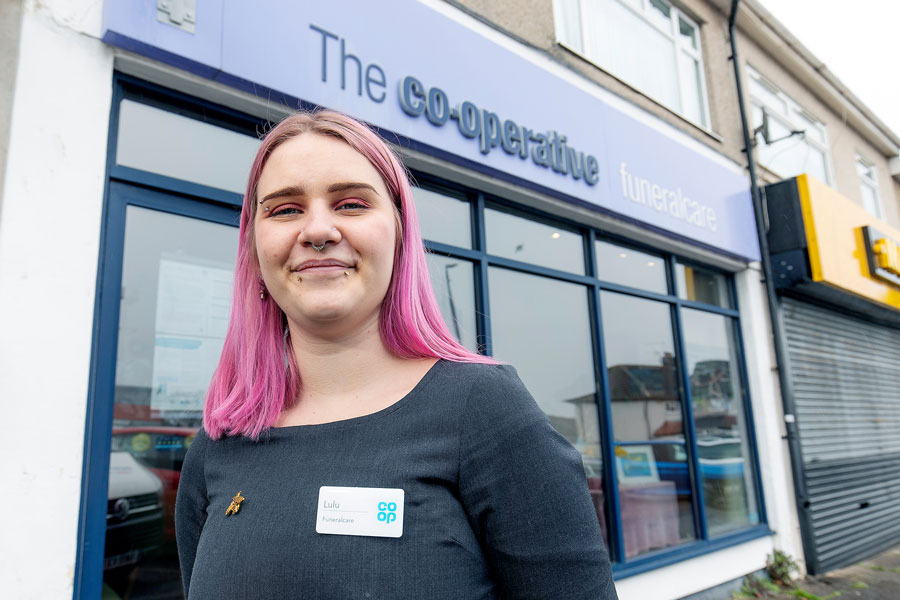 Funeral arranger Lulu Stagg outside the Co-op Funeralcare office in Rodway Road, Patchway. Photo of a young woman standing out a Co-op Funeralcare branch.